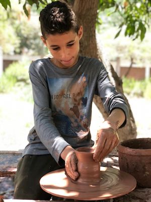 Learning about ancient Amarna: children's pottery class, Egypt