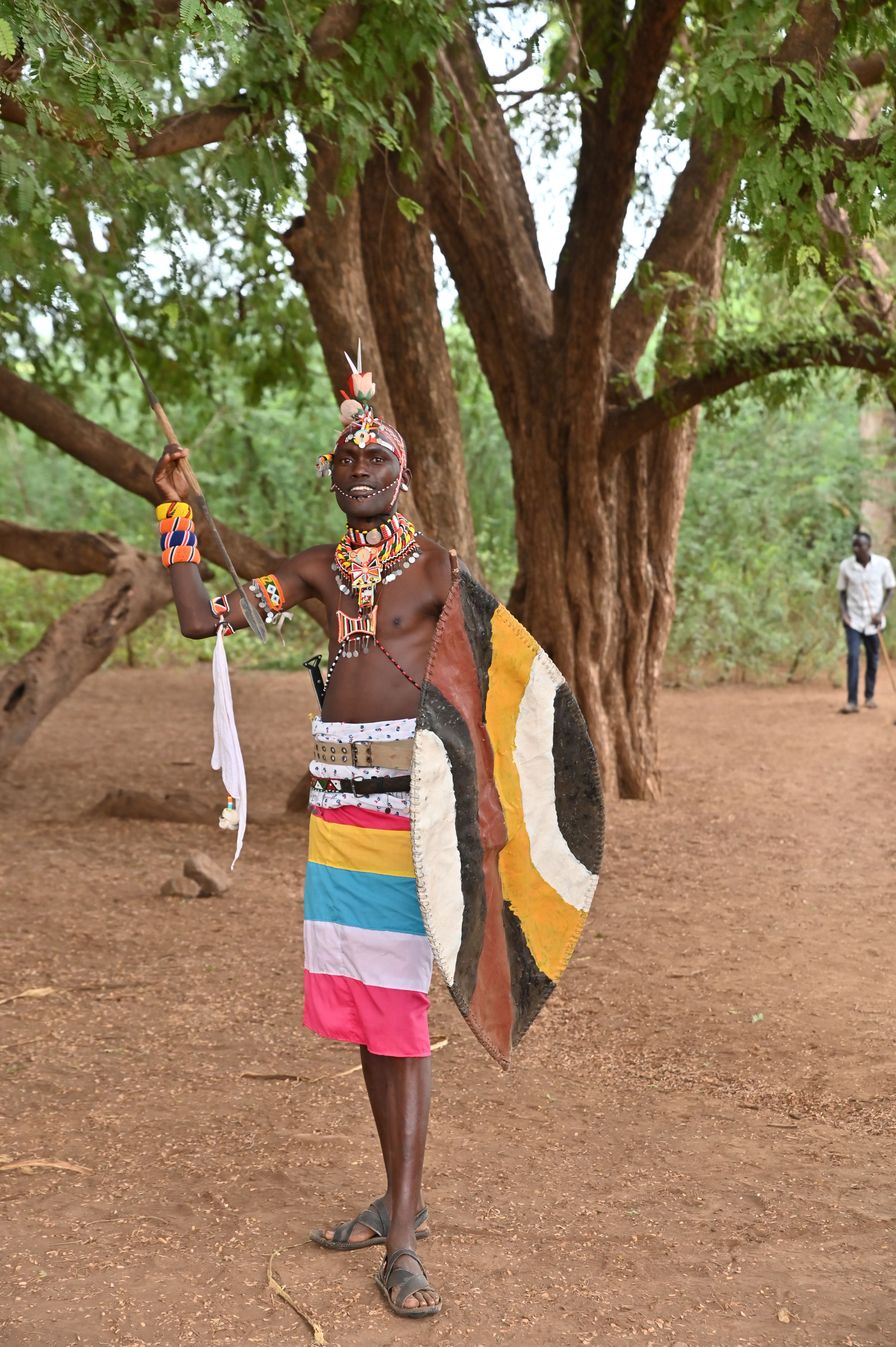 A member of the Eldume cultural dancers poses with a shield and spear made by Samuel Lekichep