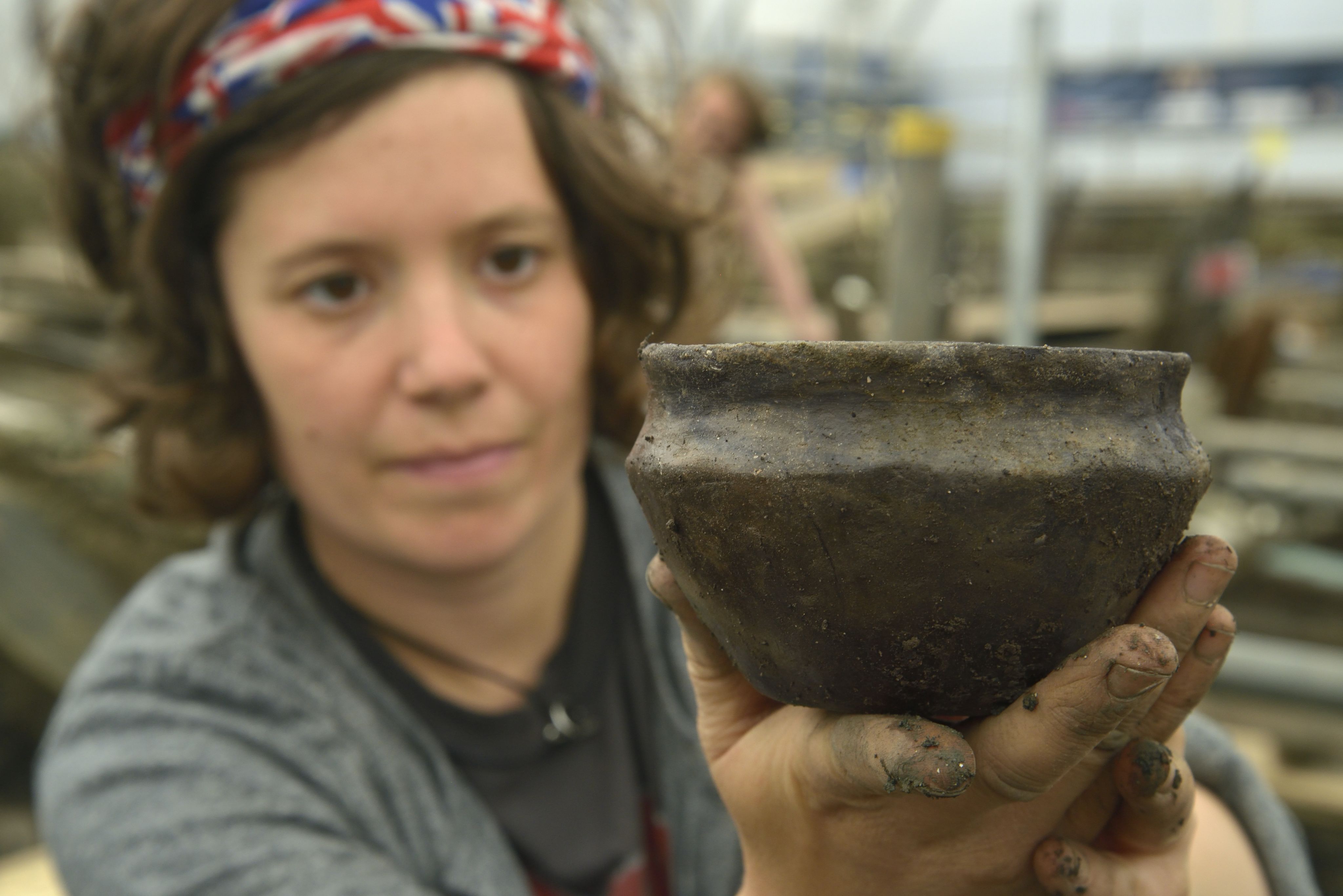 An archaeologist holding a pot