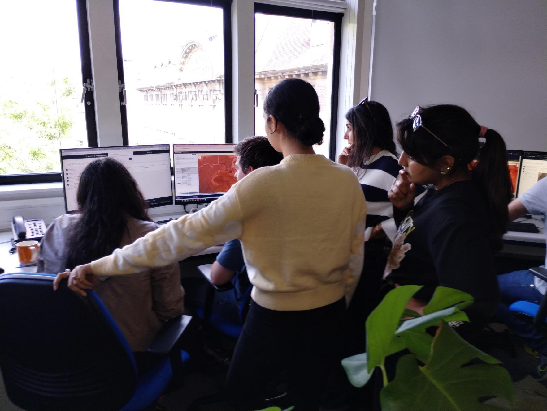 MAHSA team gathered around computer